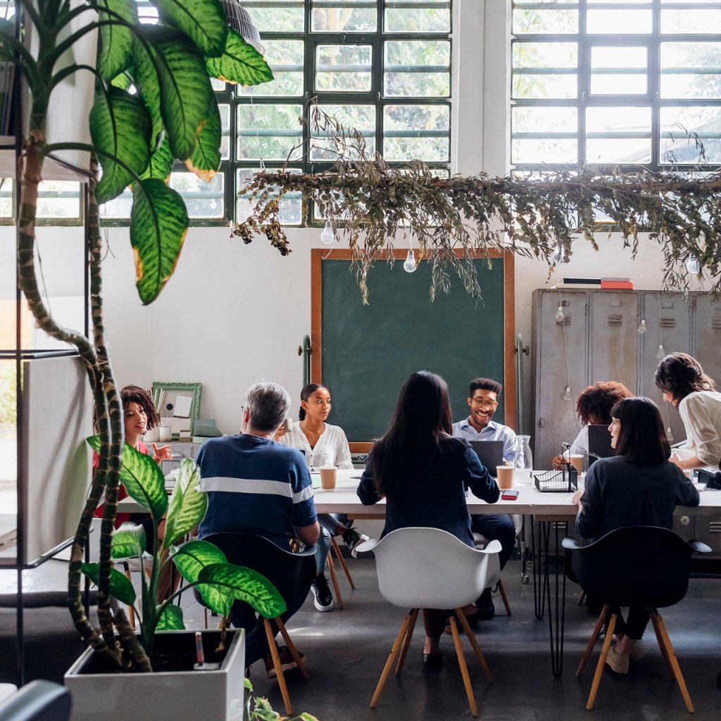 Multiracial business colleagues working at desk in coworking office