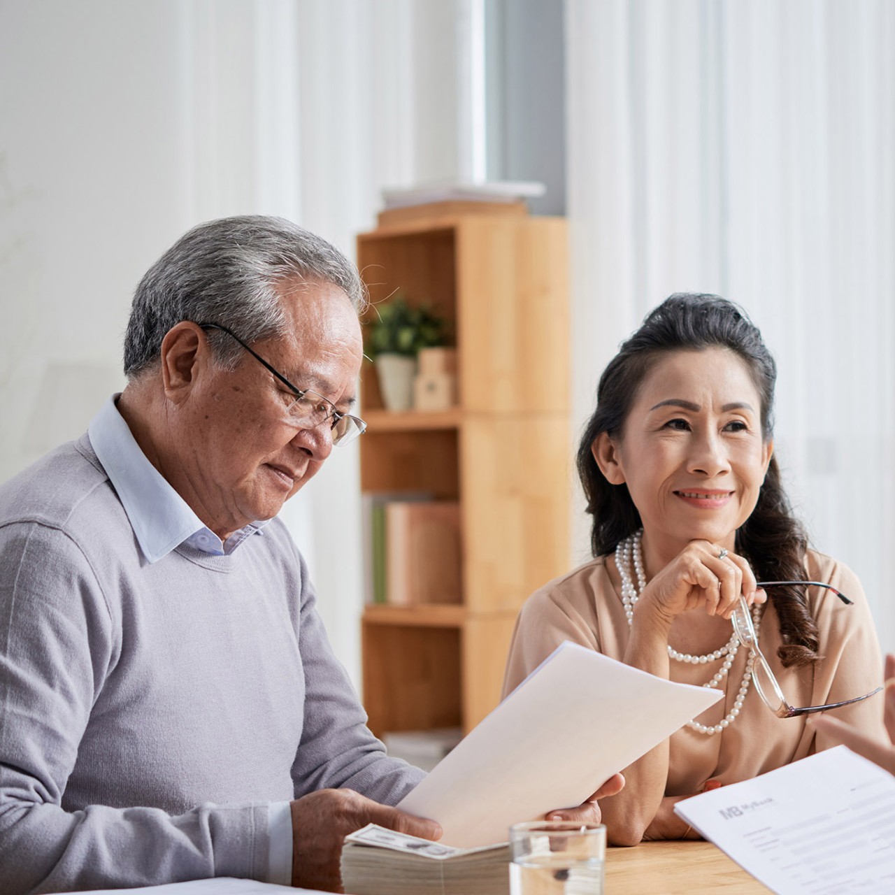 Asian aged couple meeting with real estate agent