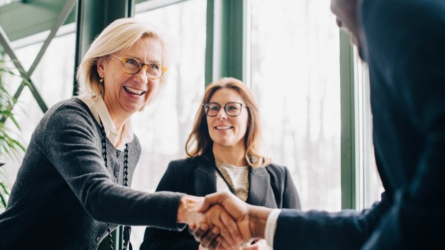 Senior business woman greeting