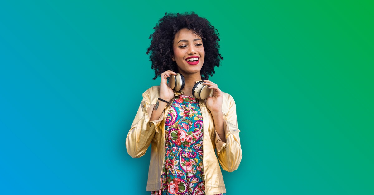Happy female holding headphones