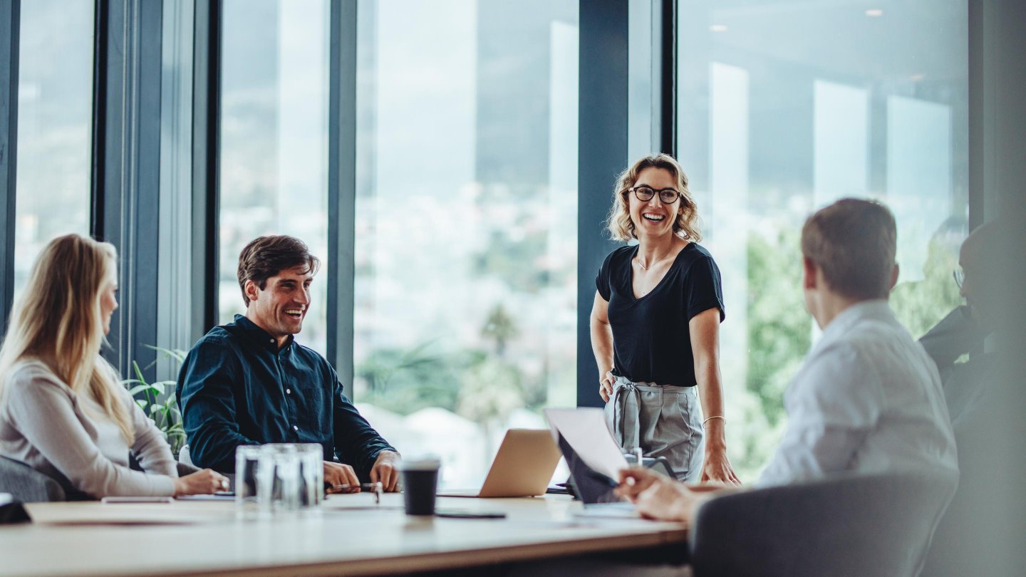  Office colleagues having casual discussion during meeting in conference room