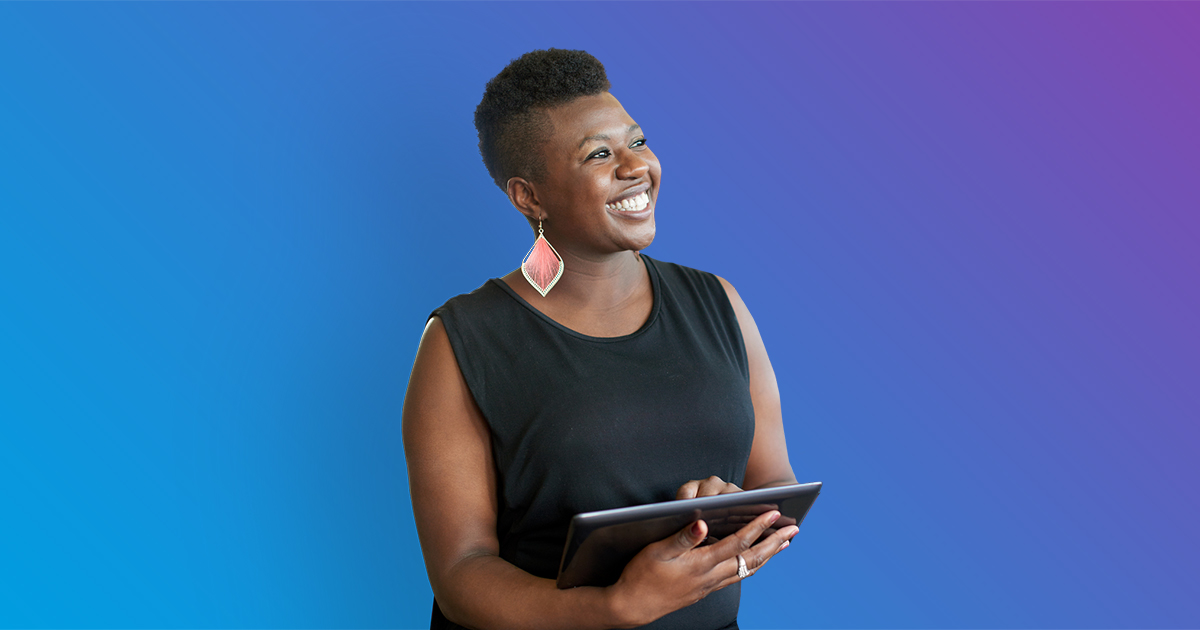 Woman smiling and holding tablet