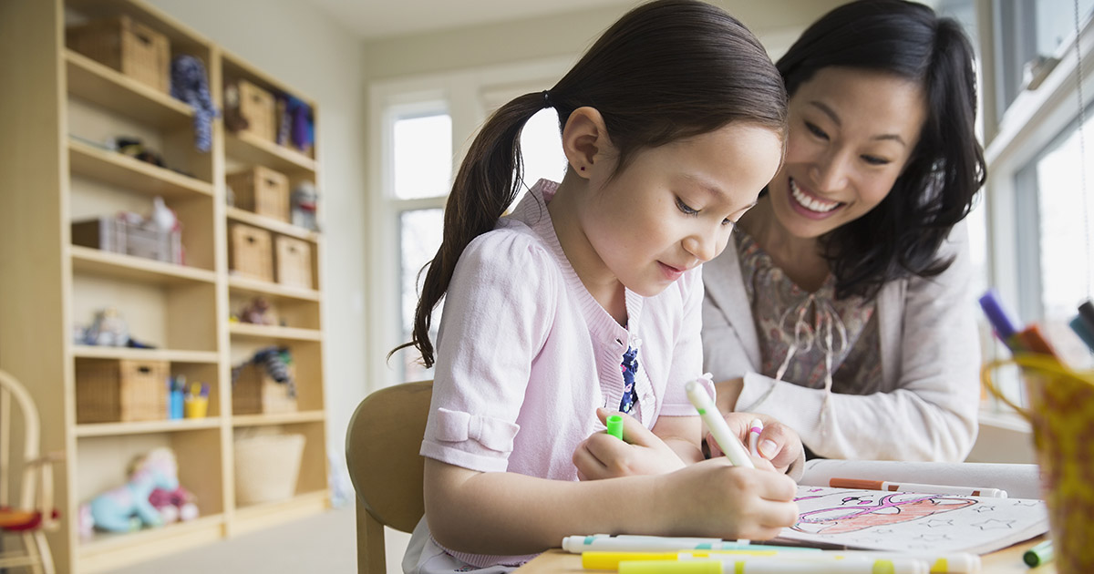 Mother and daughter coloring with markers