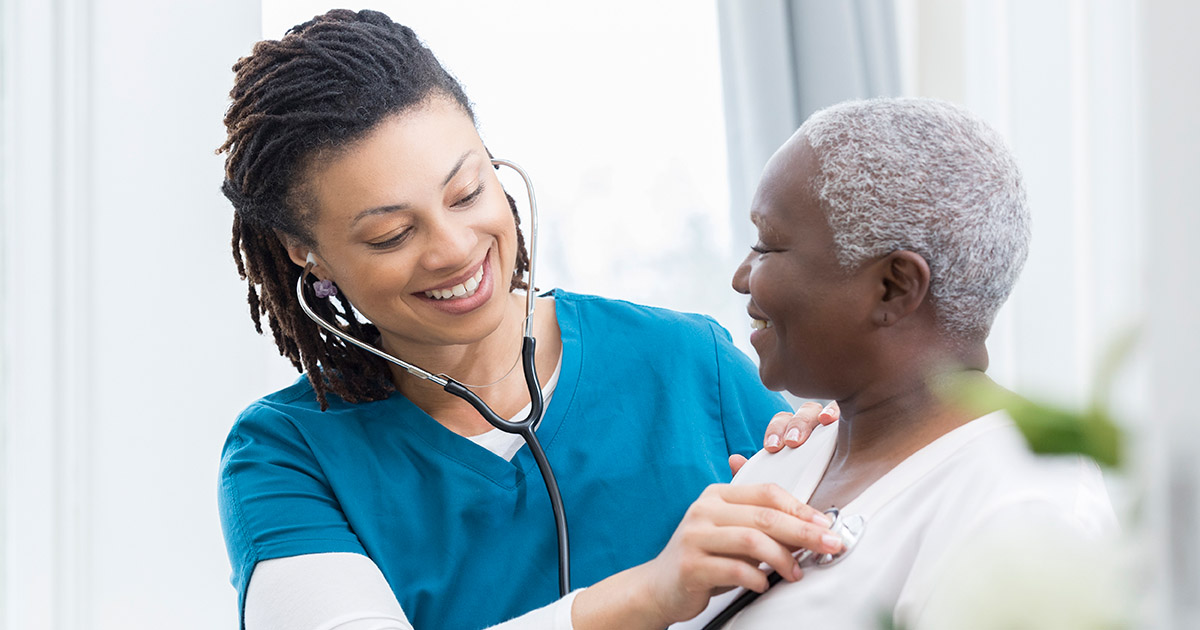 Female nurse checks patient's vital signs, medical