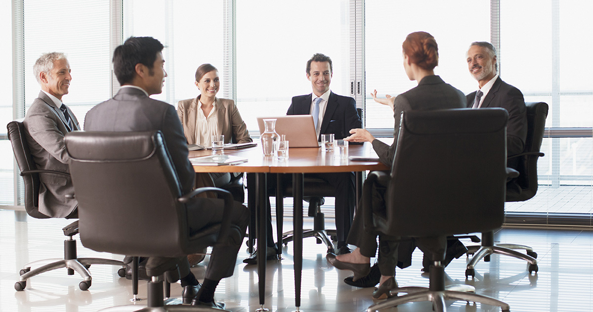 Businesspeople meeting at table in conference room, office, group