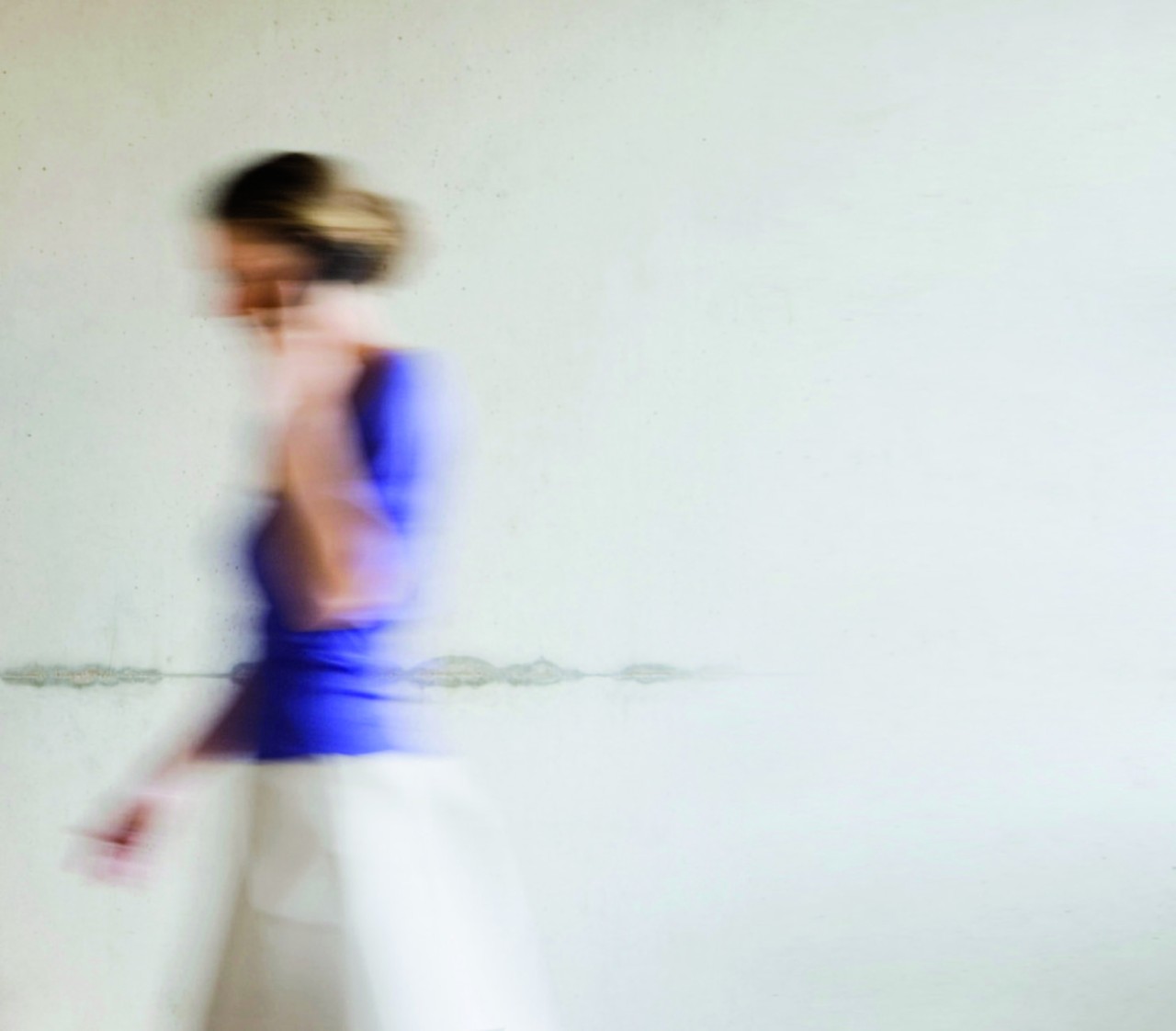 Businesswoman Hurrying Through Office