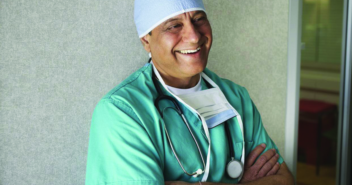 Asian male doctor smiling content healthcare provider
