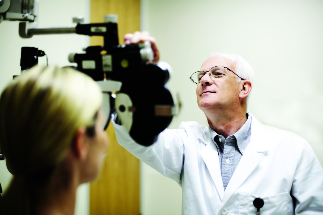 Opthamologist measuring patient's eyesight