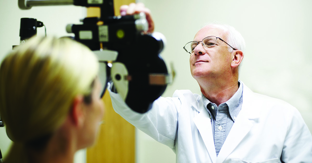 Opthamologist measuring patient's eyesight
