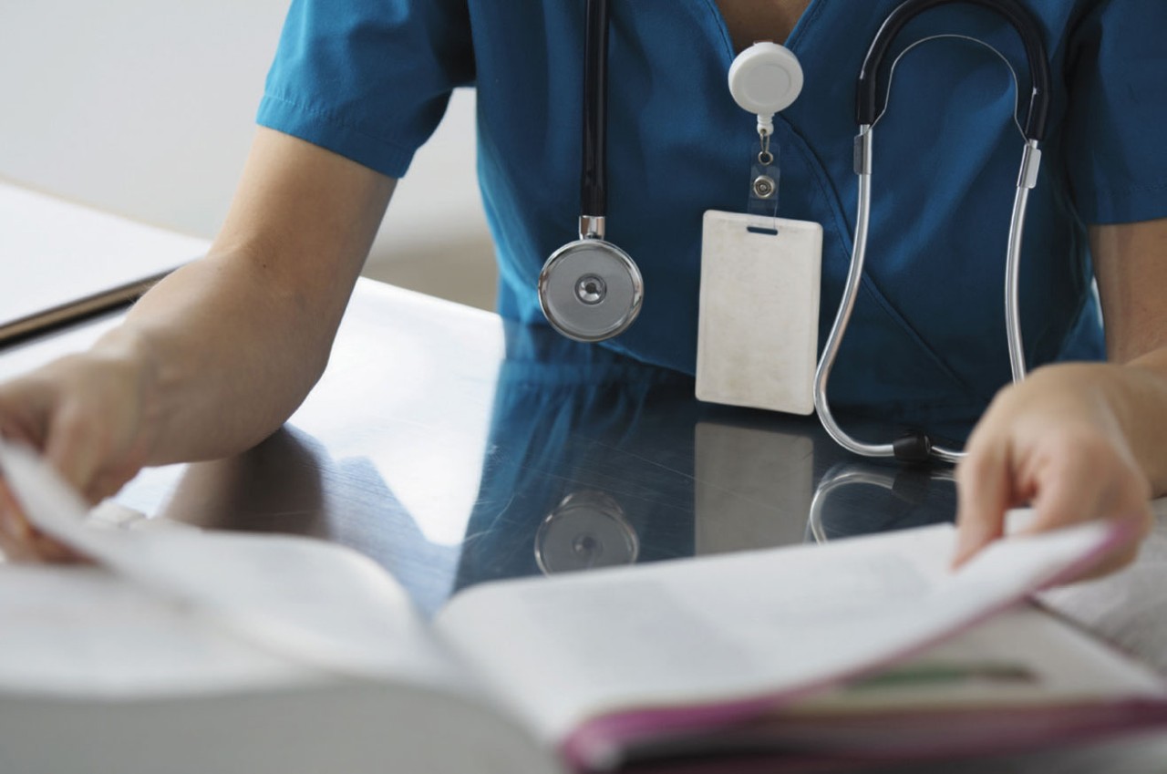 Caucasian surgeon reading book