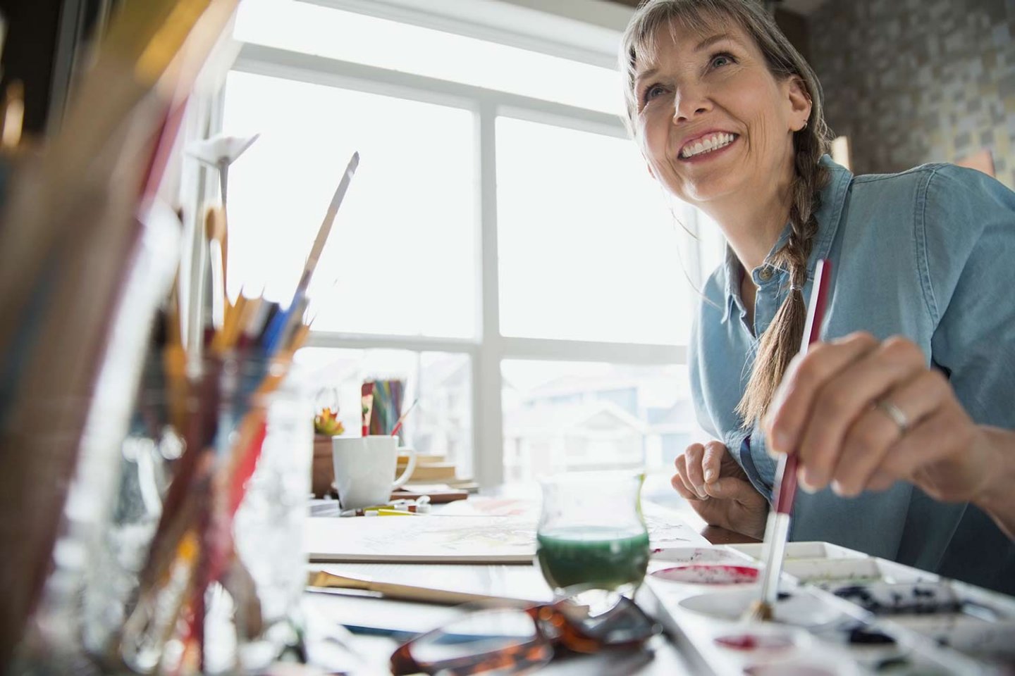 Woman painting at desk