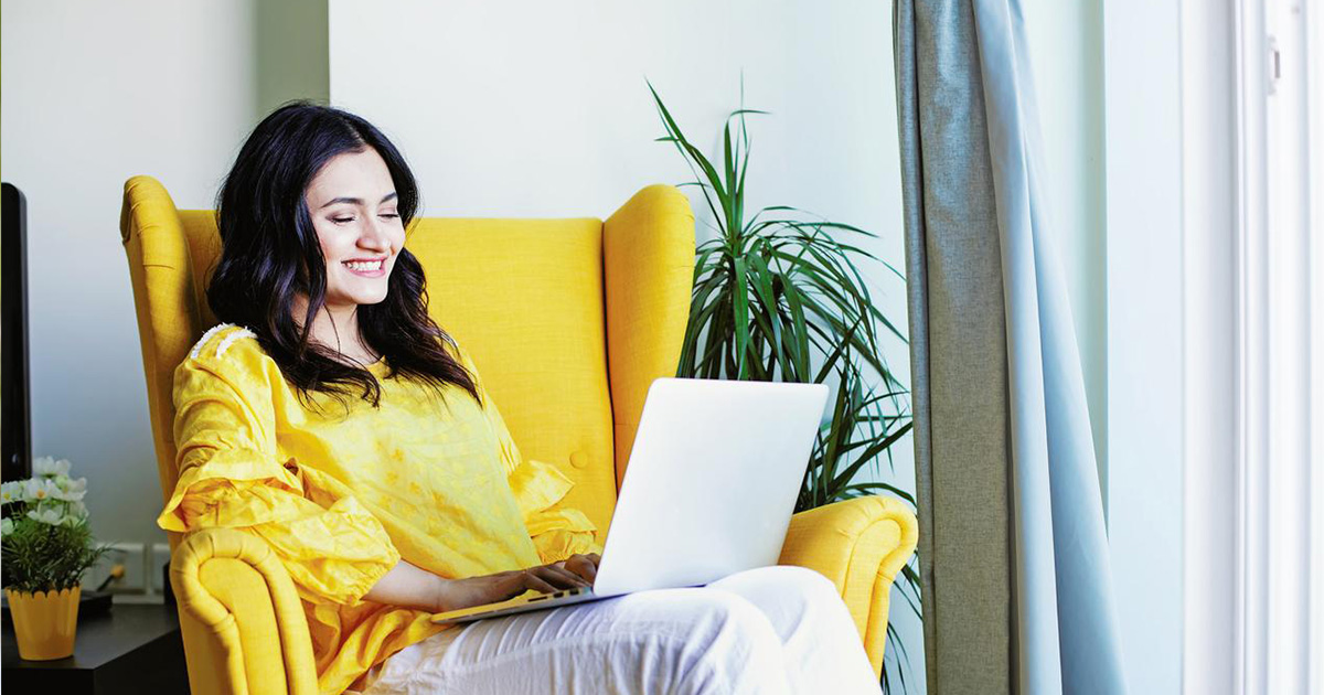 a woman wearing yellow sitting on a yellow chair