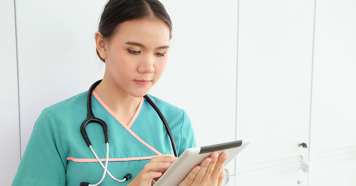 Close up asian nurse using tablet technology health care medical.