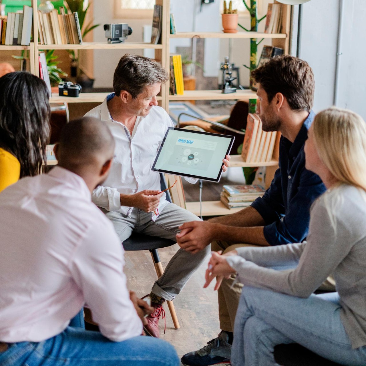 Businessman leading a presentation in loft office