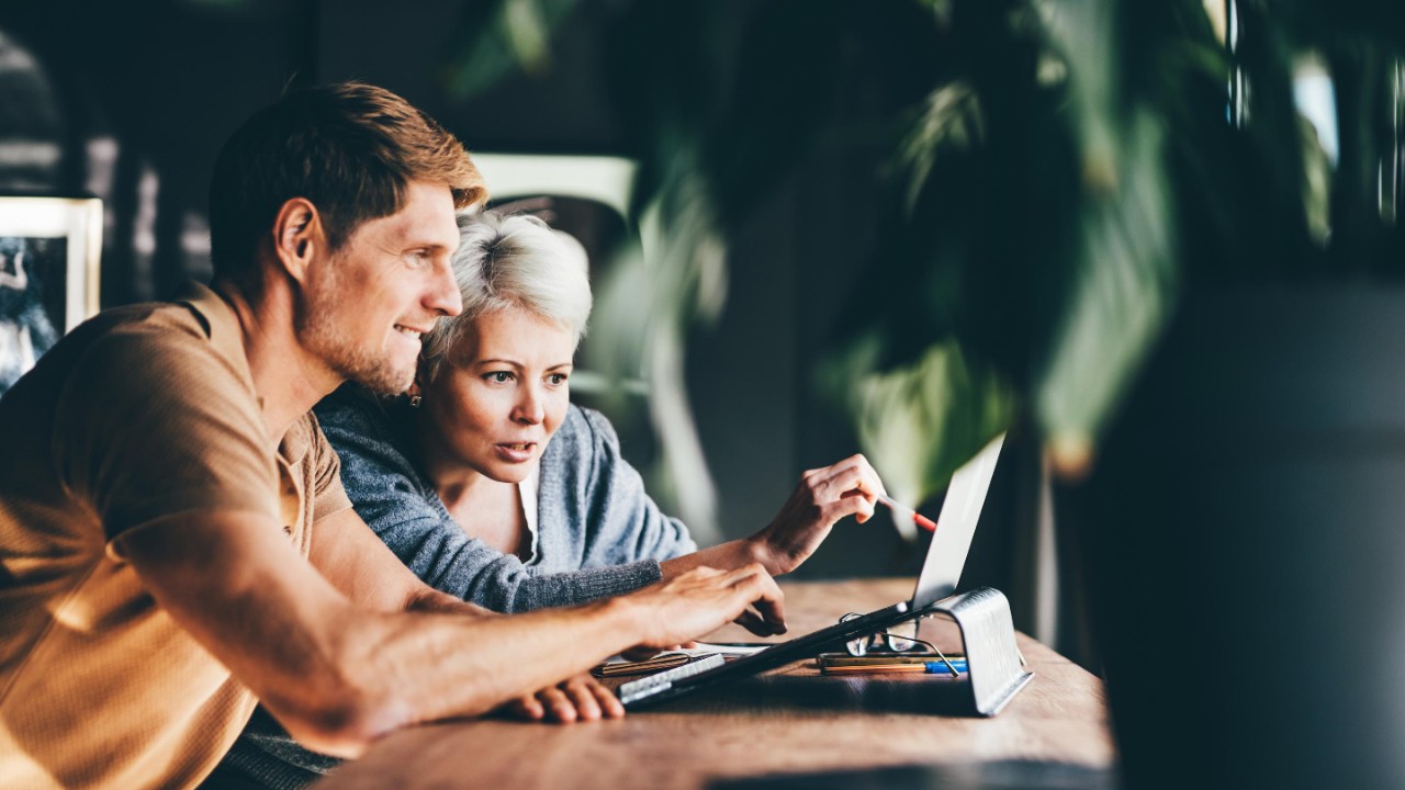 Two business people working together in the office. Businesswoman explains her vision to a colleague.