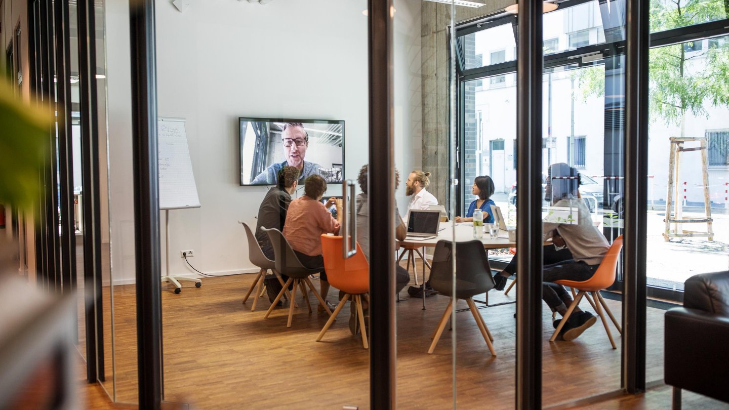 Videoconferencias de personas de negocios multiétnicas en la sala de juntas de la oficina