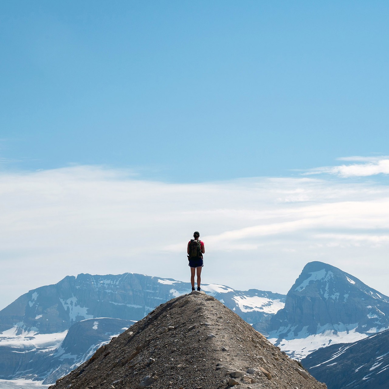 man standing on top of a mountain