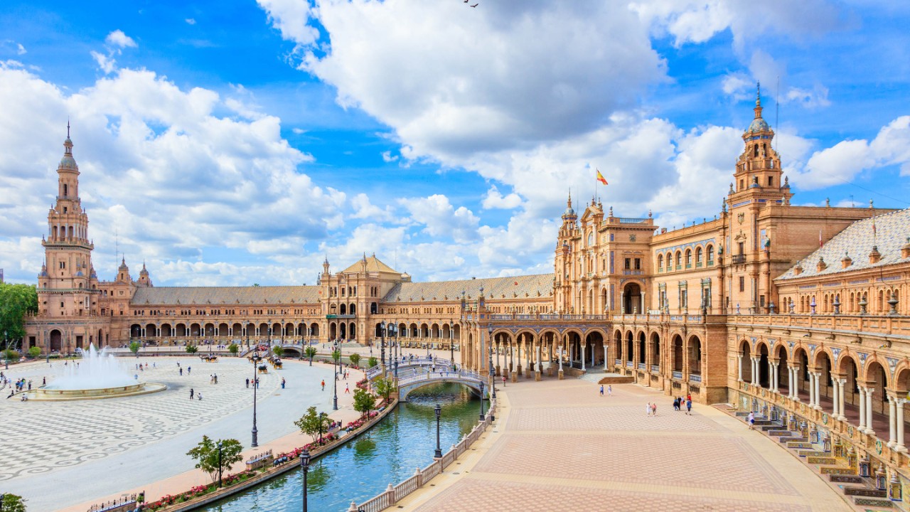 The Plaza de España is a plaza in the Parque de María Luisa, in Seville, Spain. It was built in 1928 for the Ibero-American Exposition of 1929. It is a landmark example of Regionalism Architecture, mixing elements of the Baroque Revival, Renaissance Revival and Moorish Revival (Neo-Mudéjar) styles of Spanish architecture.
