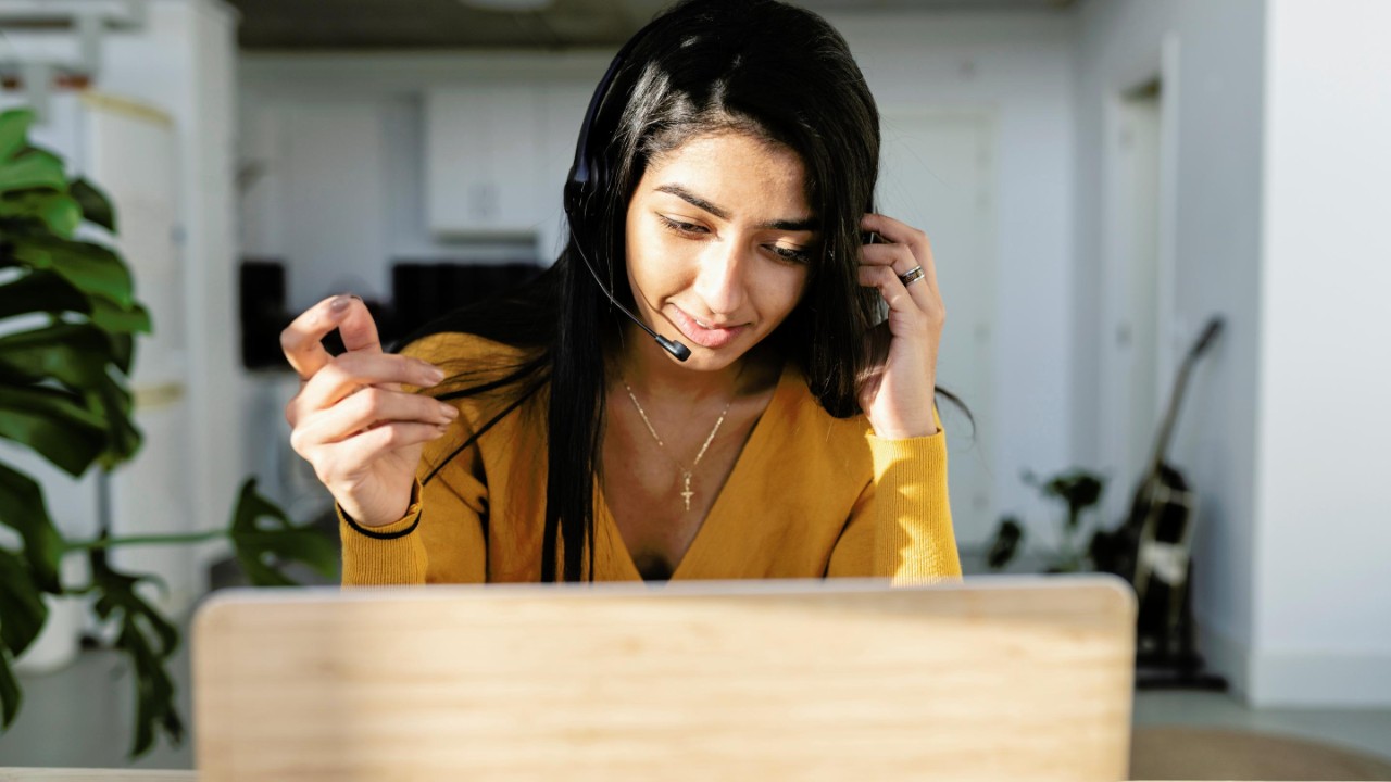indian woman work from home with computer and headset, meeting video call