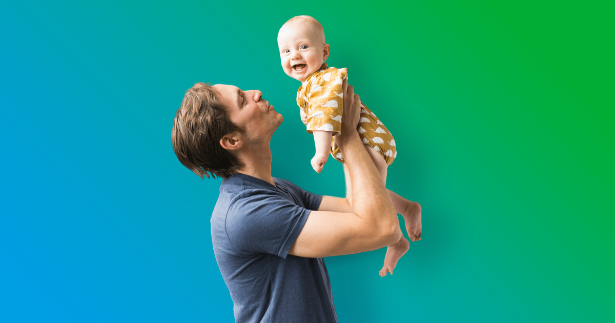 Man holding up laughing baby - blue to green gradient