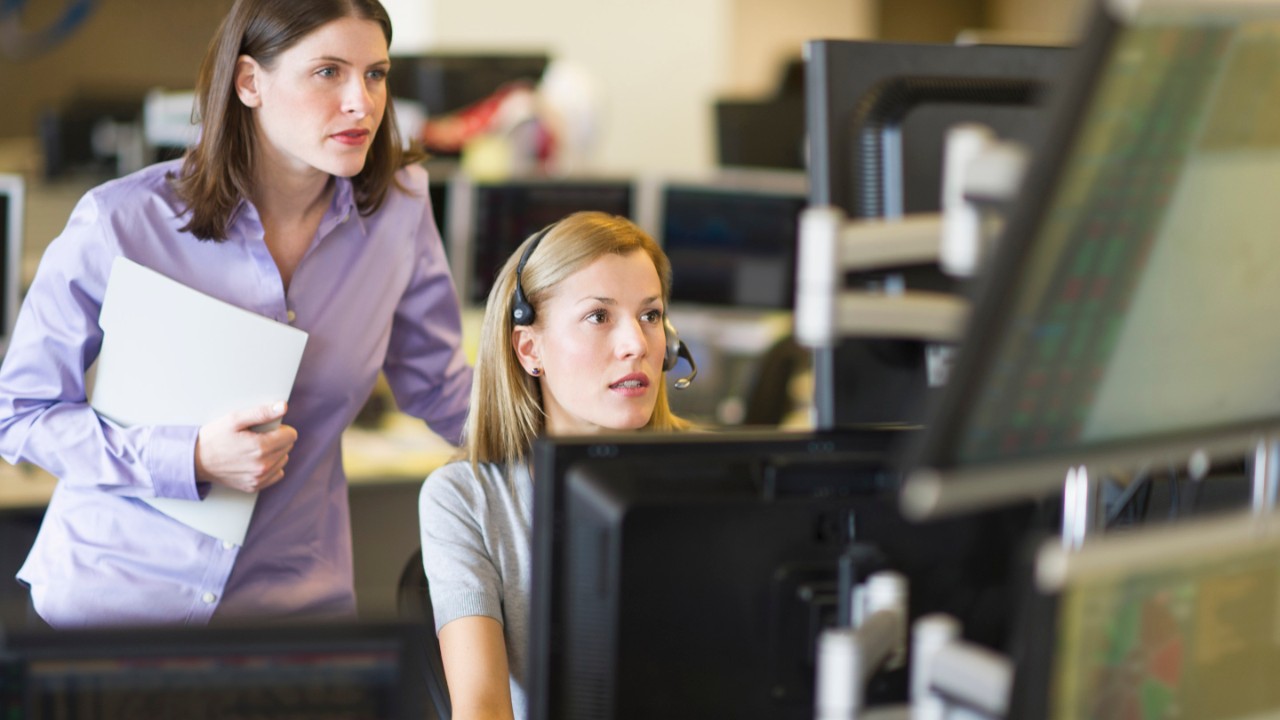 USA, New York, New York City, Traders at trading desk