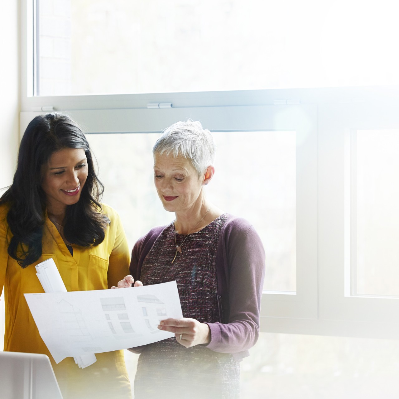 Women discussing paper works