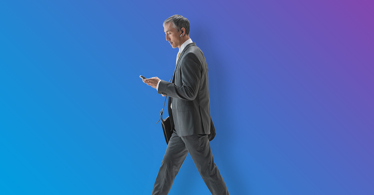 Man walking looking at cell phone - blue to purple gradient