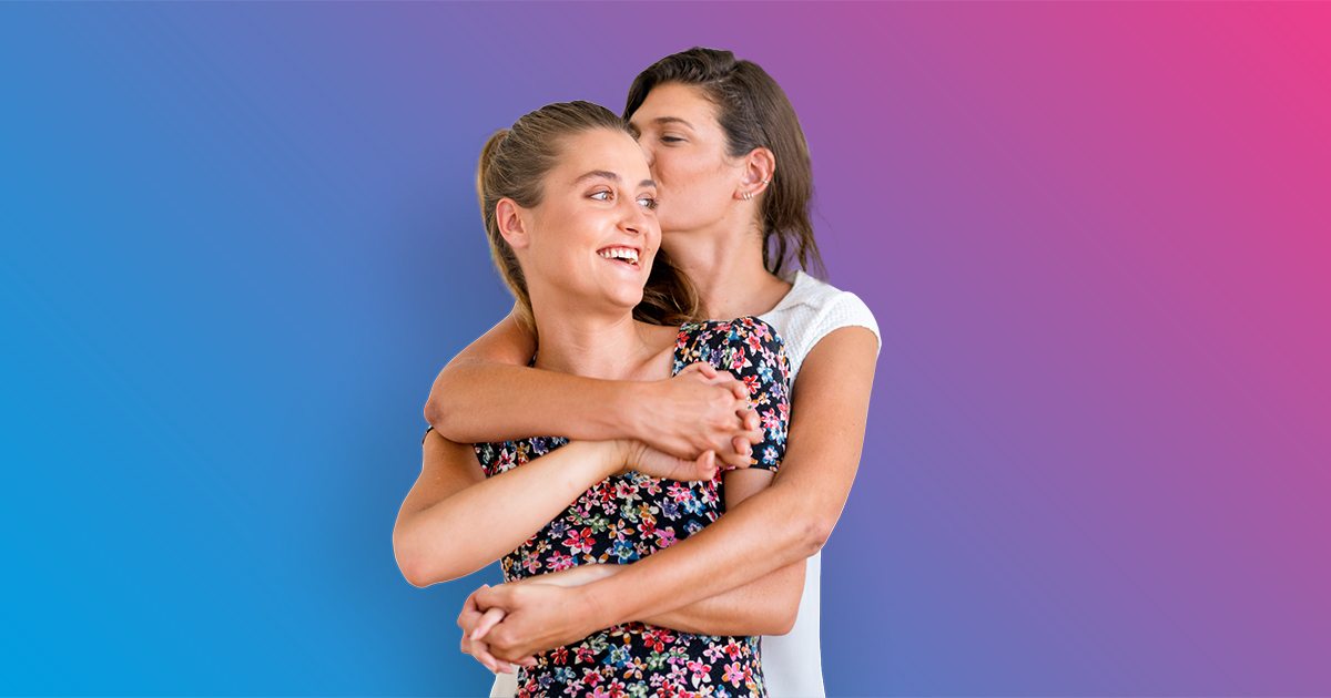 Two women hugging - blue to pink gradient