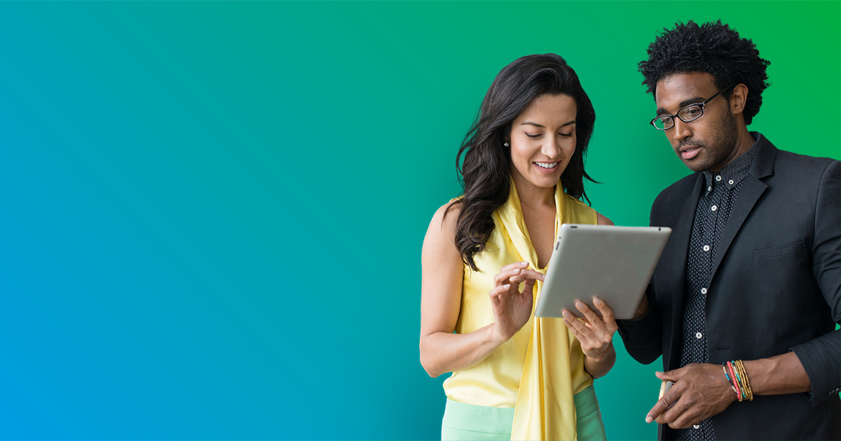 Man and woman talking and looking at tablet