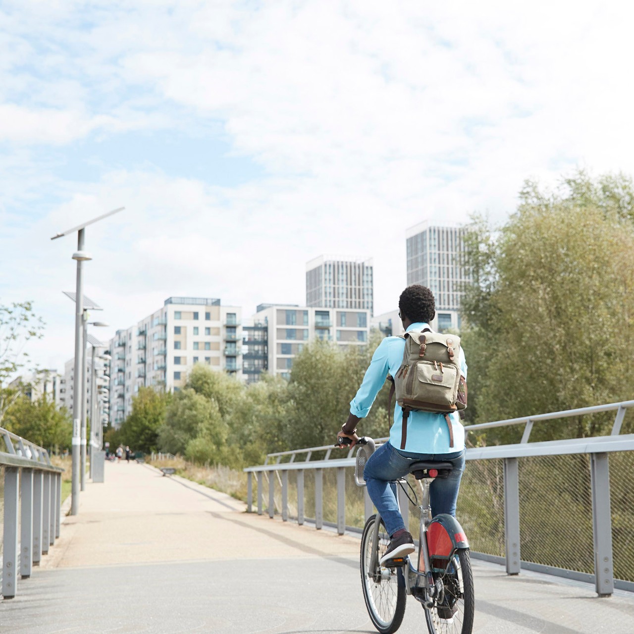 a man cycling into the city