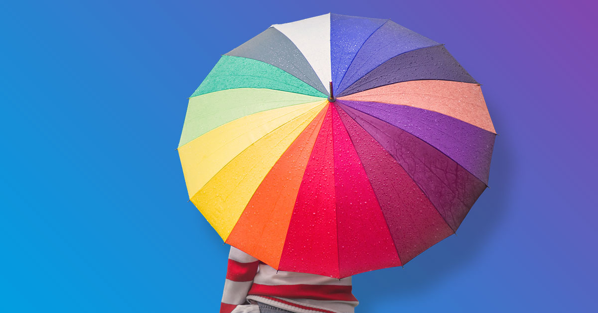 Person holding rainbow color umbrella