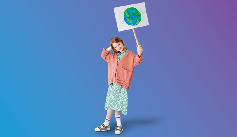 Little girl in dress holding up sign of a child's drawing of a planet Earth - blue to purple gradient