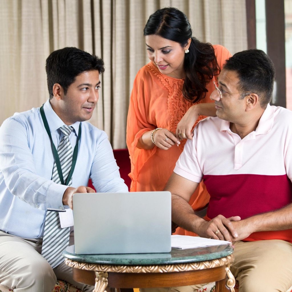 Financial advisor discussing with Indian family at home