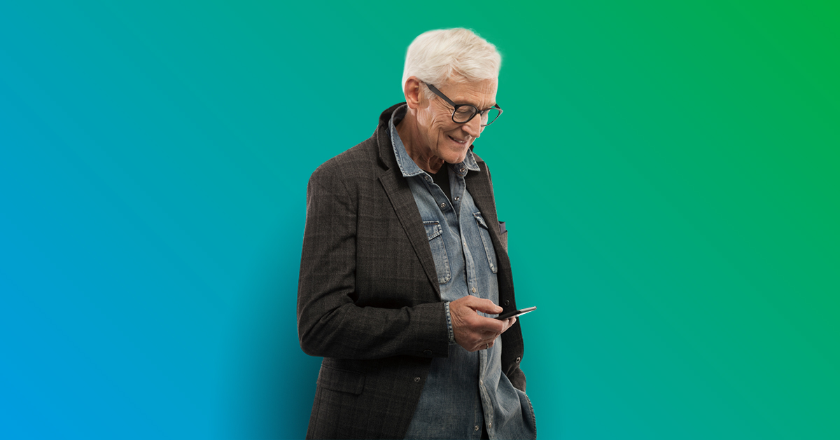 Elderly man standing looking down at cell phone - blue to green gradient