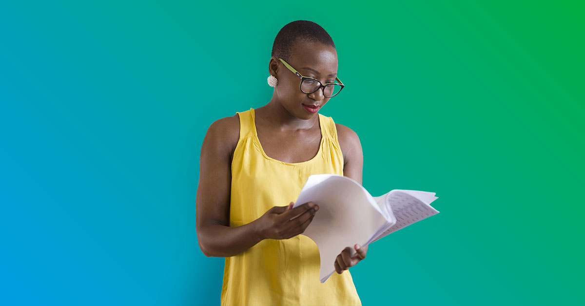 Women in yellow top standing reading documents - blue to green gradient