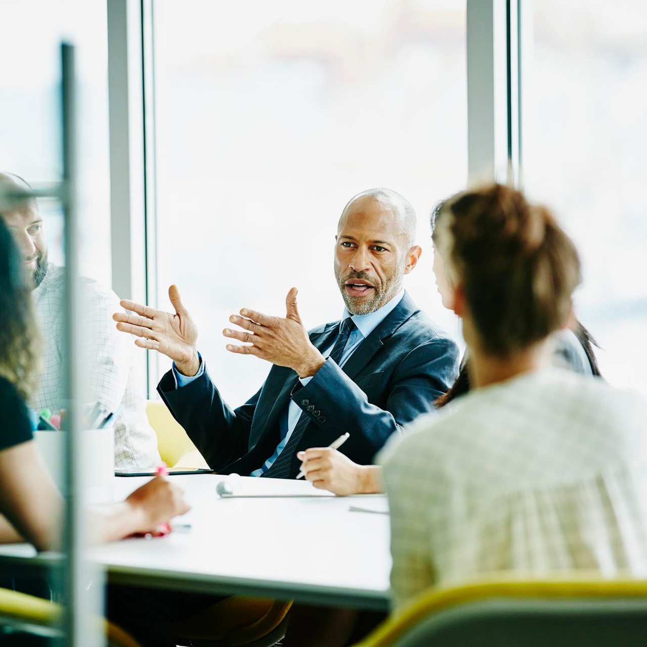 Mature businessman leading project meeting in office conference room