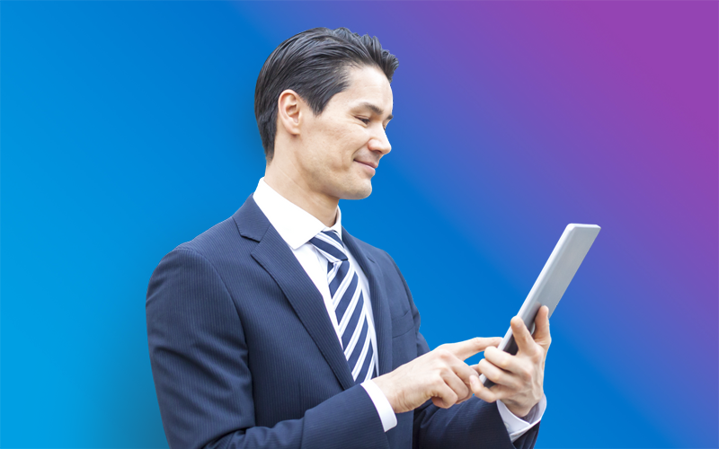 Man in a suit looking at tablet