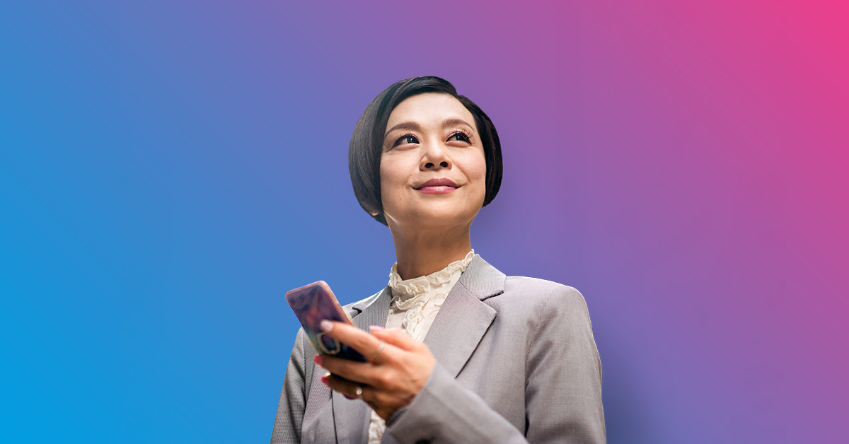 smiling asian businesswoman holding cell phone