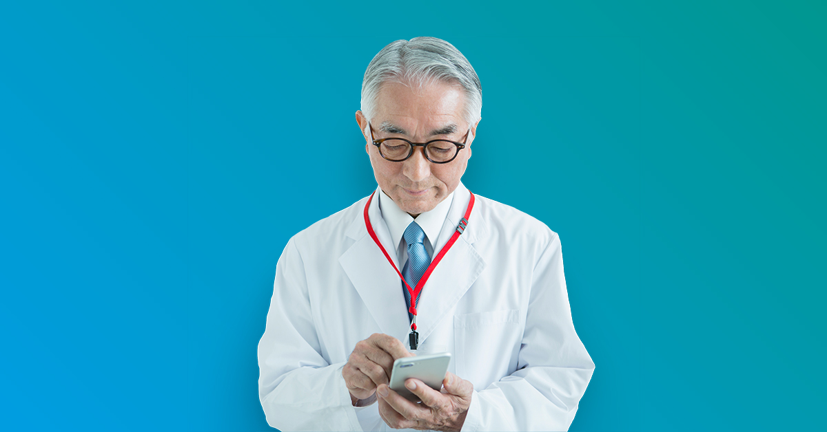 Male doctor in white lab coat and red stethoscope around neck typing into cell phone - blue to turquoise gradient