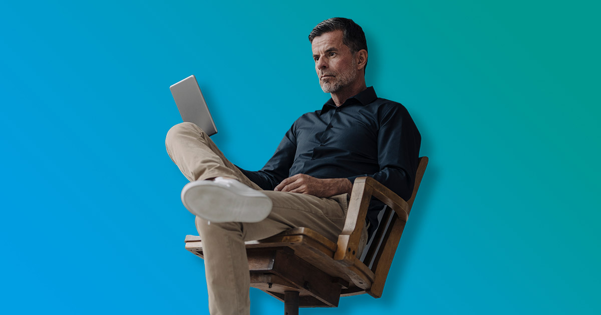 Professional man reclining in office chair blue and gradient background