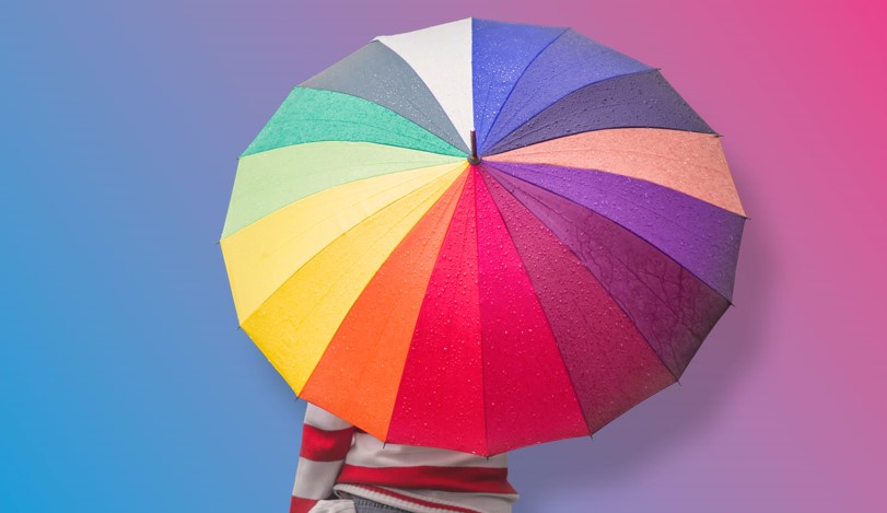 person holding rainbow umbrella