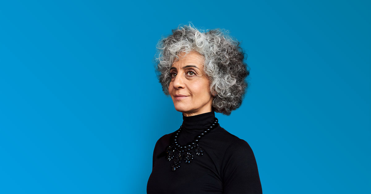 Smiling elderly woman - blue teal