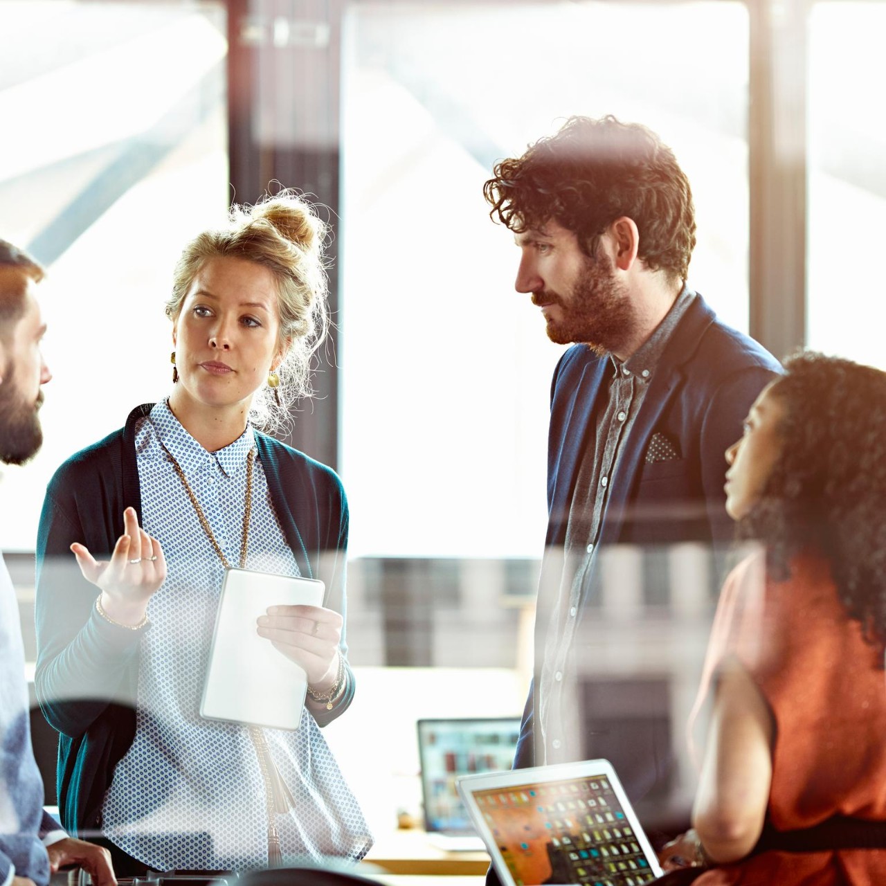 Men and women talking in modern office