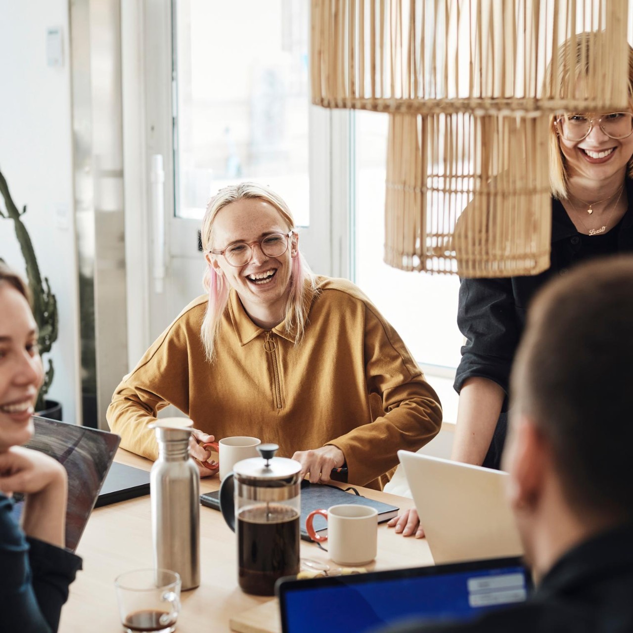 A group of diverse people having a conversation while smiling