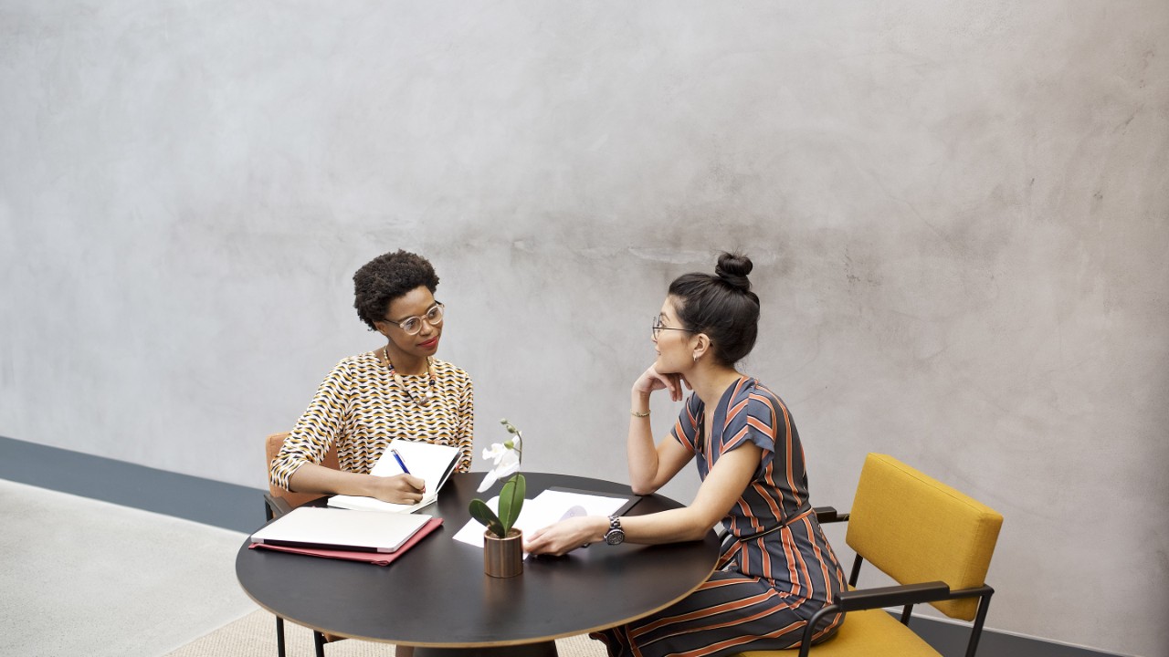 Black African and Asian businesswomen in a meeting