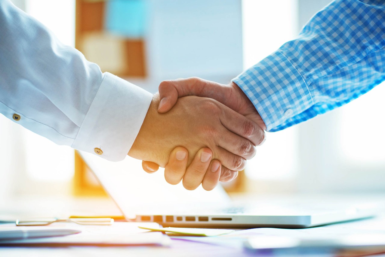 businessmen shaking hands in the office.