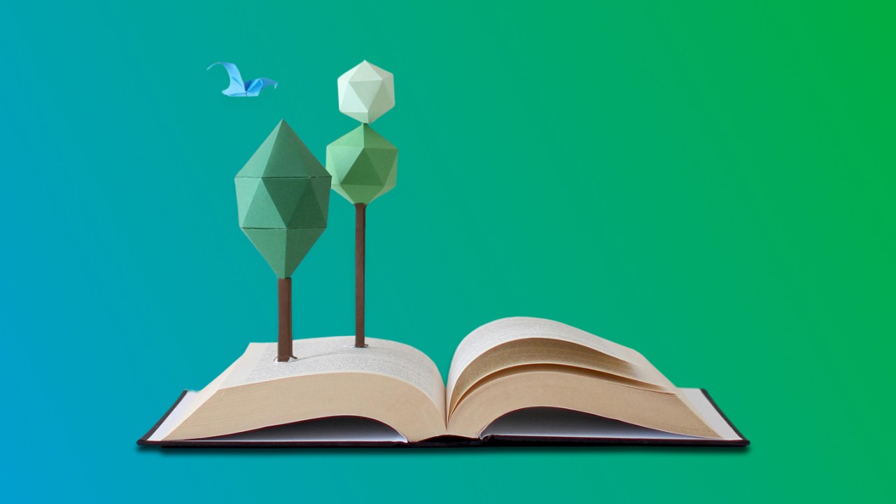open book with origami tree and bird on blue and green gradient background