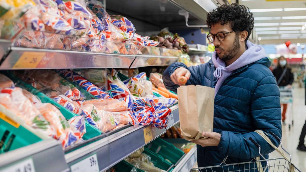 Man picking vegetables at the supermarket