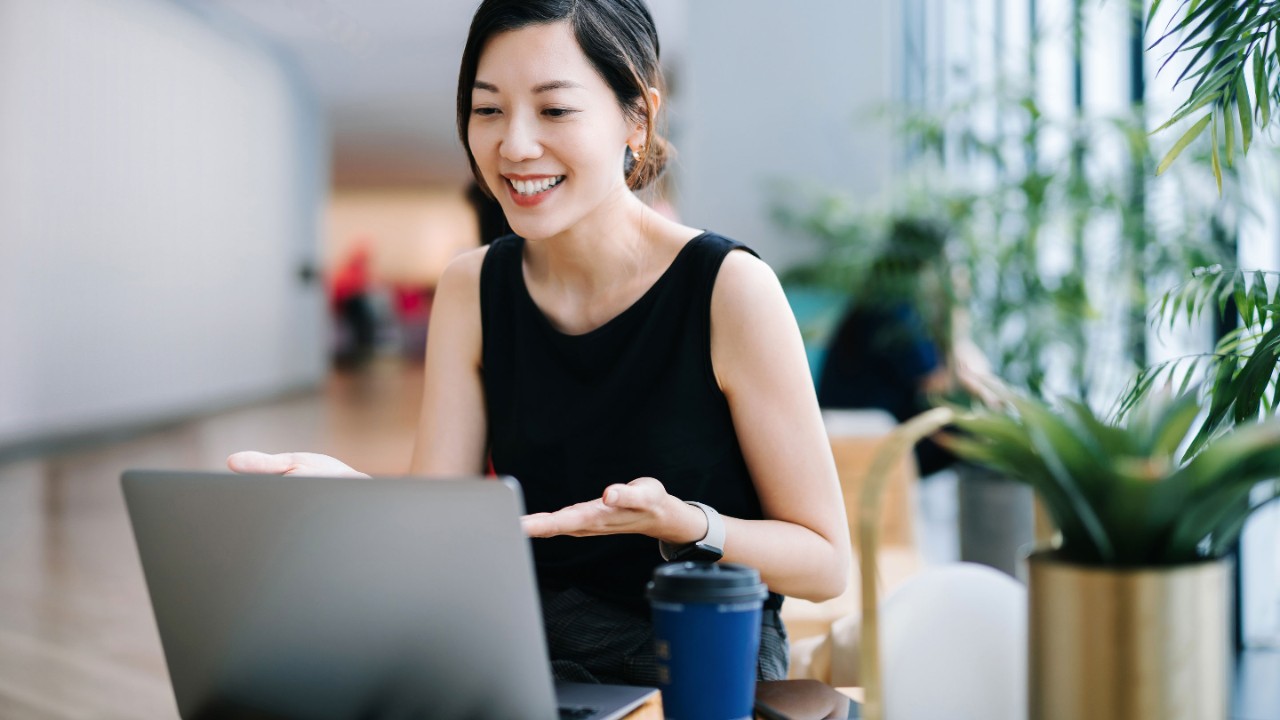 Smilling young professional video conferencing