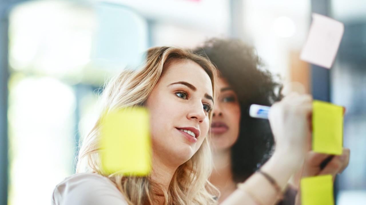 Shot of two colleagues having a brainstorming session in a modern office.